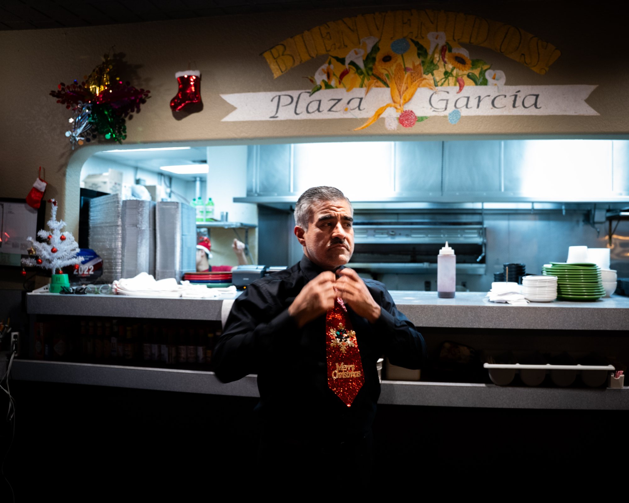 The hand-painted ¡Bienvenidos! Plaza García sign above the kitchen pass